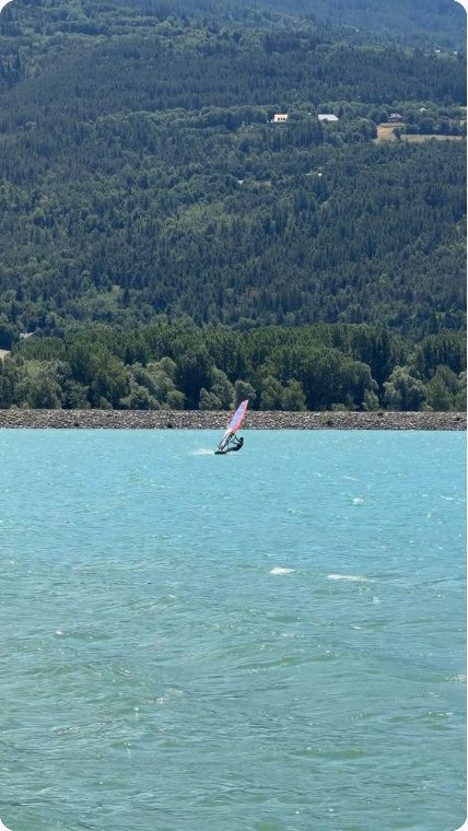 Vidéo UGC de Geoffrey : Planche à voile sur une eau turquoise, Séquence sportive et paysage au bord de l’eau